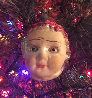 Christmas ornament on tree: antique baby head